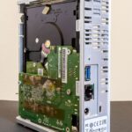 A monitor displays a cloud server network diagram with connected nodes and data routes.