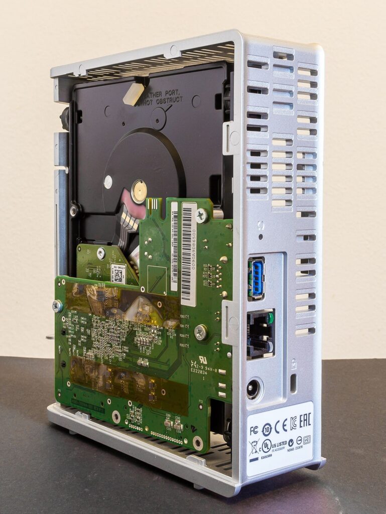 A monitor displays a cloud server network diagram with connected nodes and data routes.