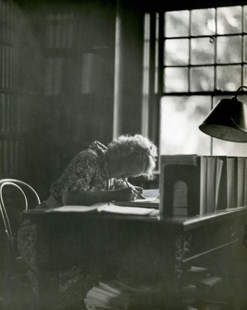 student revising with notes and flashcards at a desk