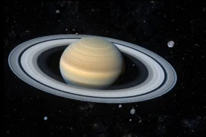 Saturn and its distant moon families against a star field