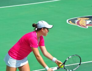 A tennis player ready at the net during a match