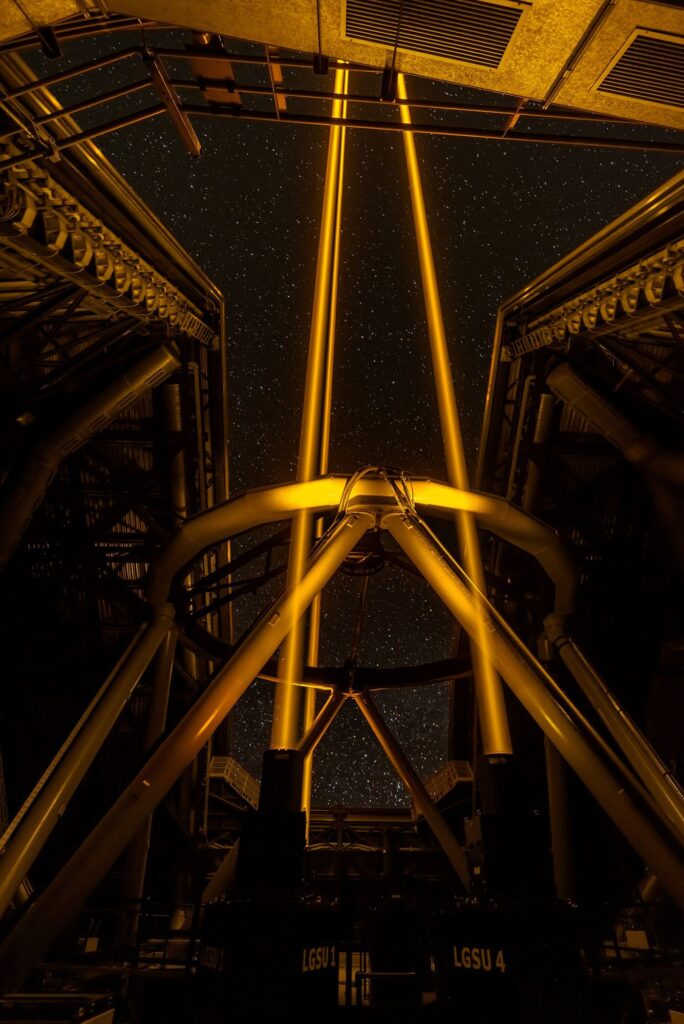 telescope pointed at a star-filled night sky